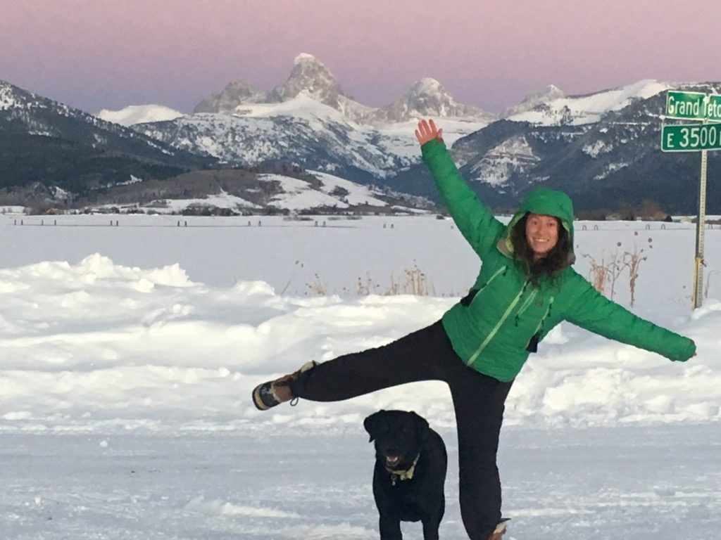 Rochelle poses with her dog in the snow at the Grand Tetons